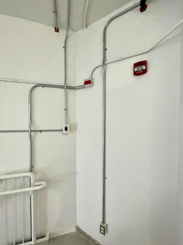 white walls of a stairwell with polished metal tubing