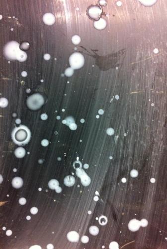 white drops scattered on black tabletop