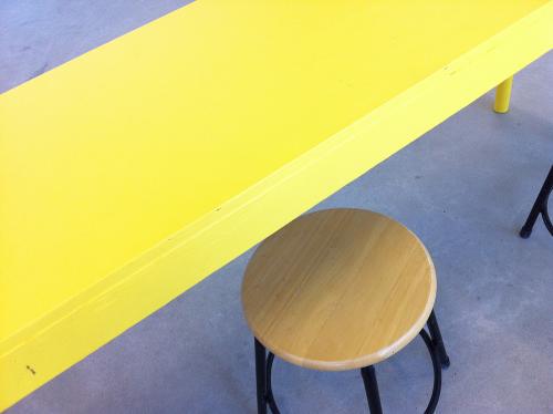yellow table and wooden topped stool